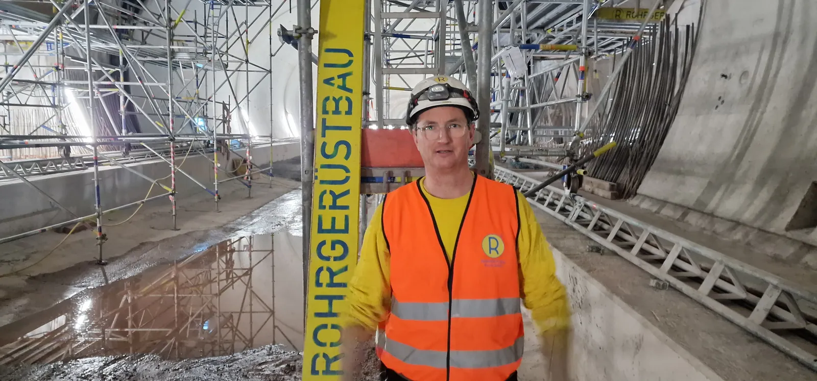 Scaffolder at work inside a tunnel / interior scaffold